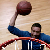 Player dunking basketball into hoop