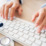 Doctor's hands on keyboard